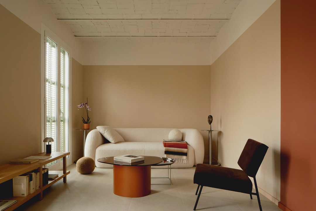 Viladomat Apartment in Barcelona by Colombo Architecture - living room with boucle sofa and terracotta coffee table