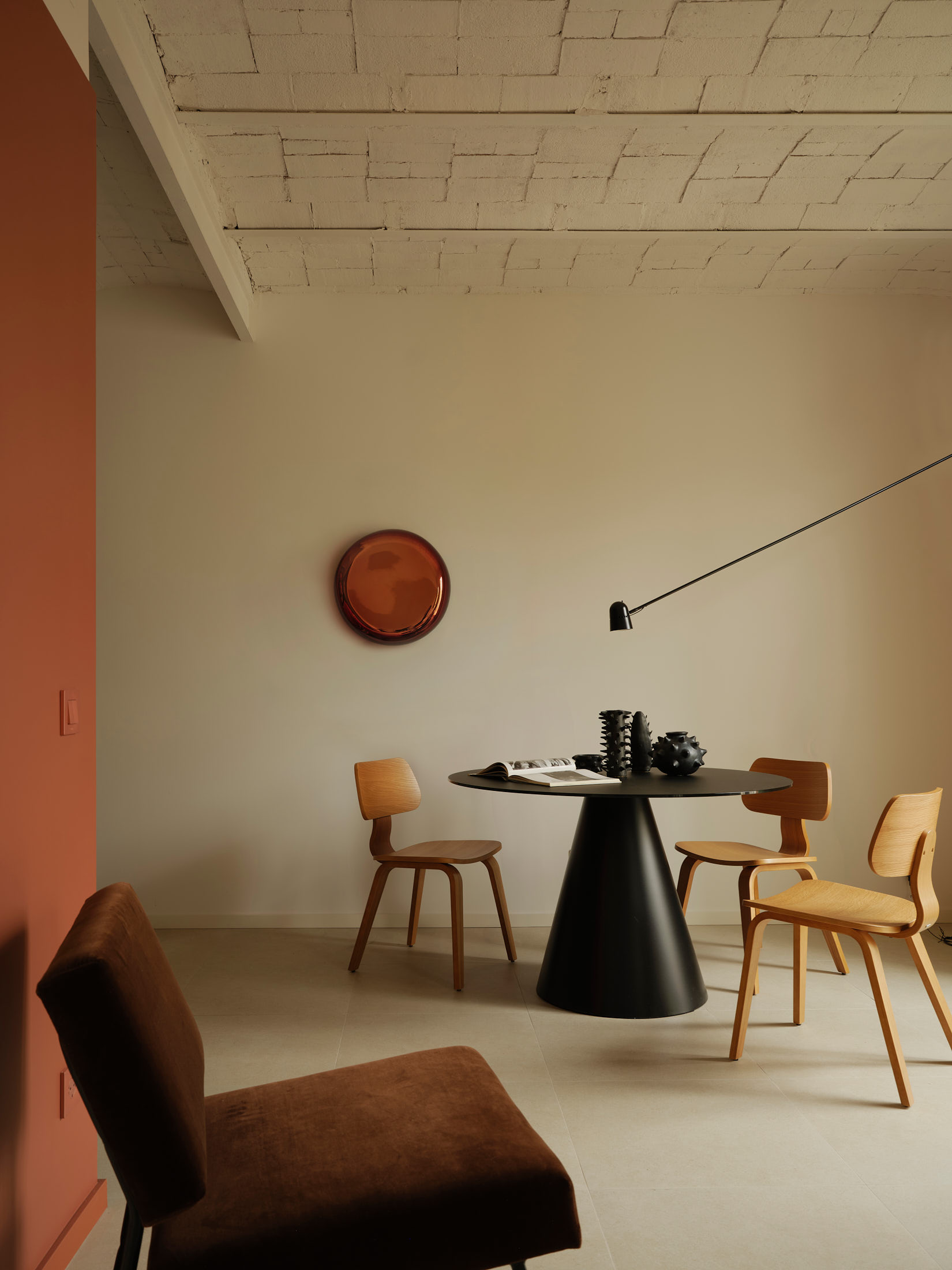 Viladomat Apartment in Barcelona by Colombo Architecture - dining area with black glass table and Counterbalance lamp