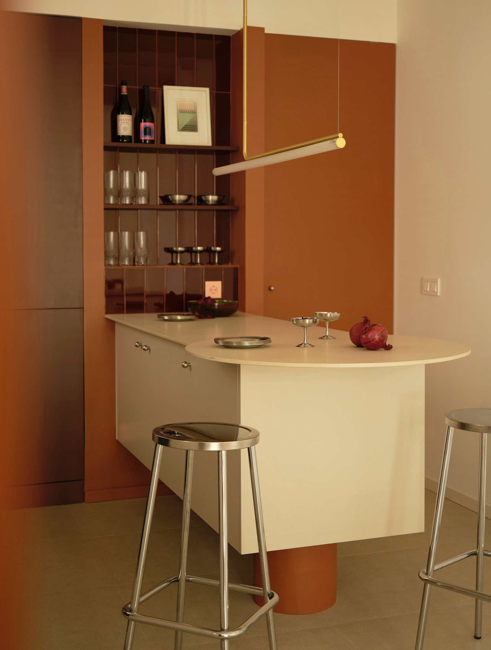 Viladomat Apartment in Barcelona by Colombo Architecture - red tiled niche with glassware shelving and kitchen island