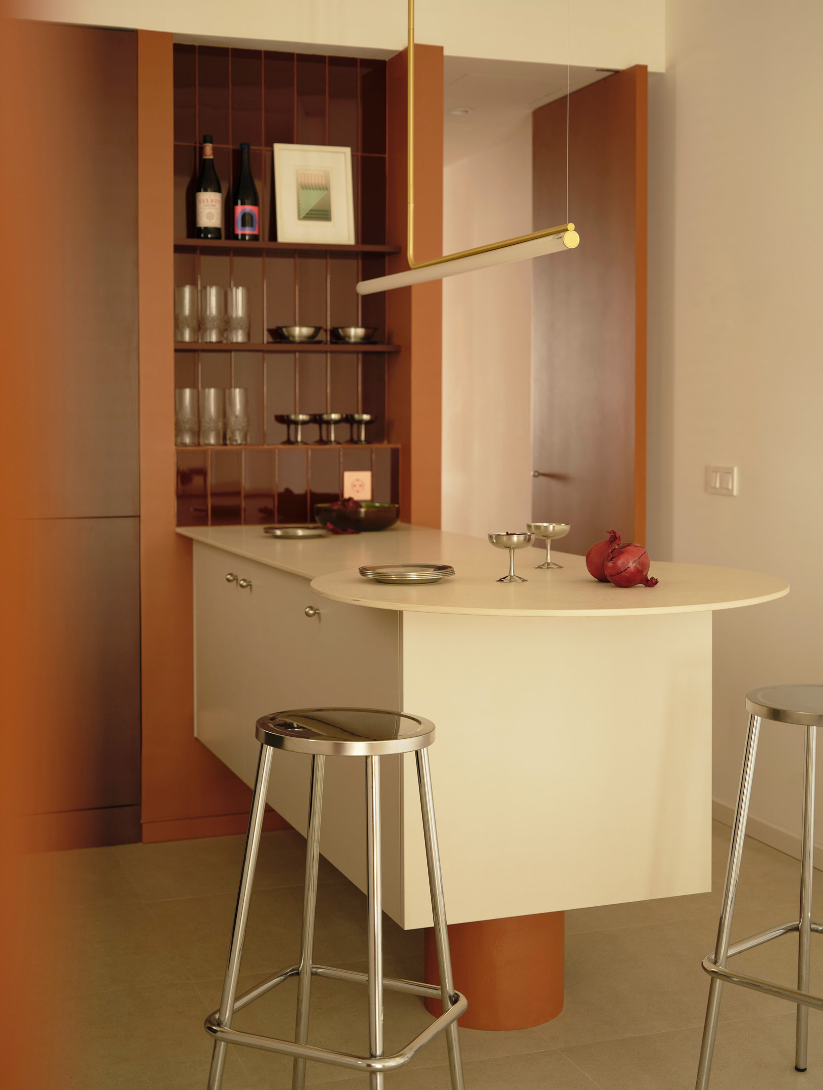 Viladomat Apartment in Barcelona by Colombo Architecture - suspended kitchen island with round table and steel stools
