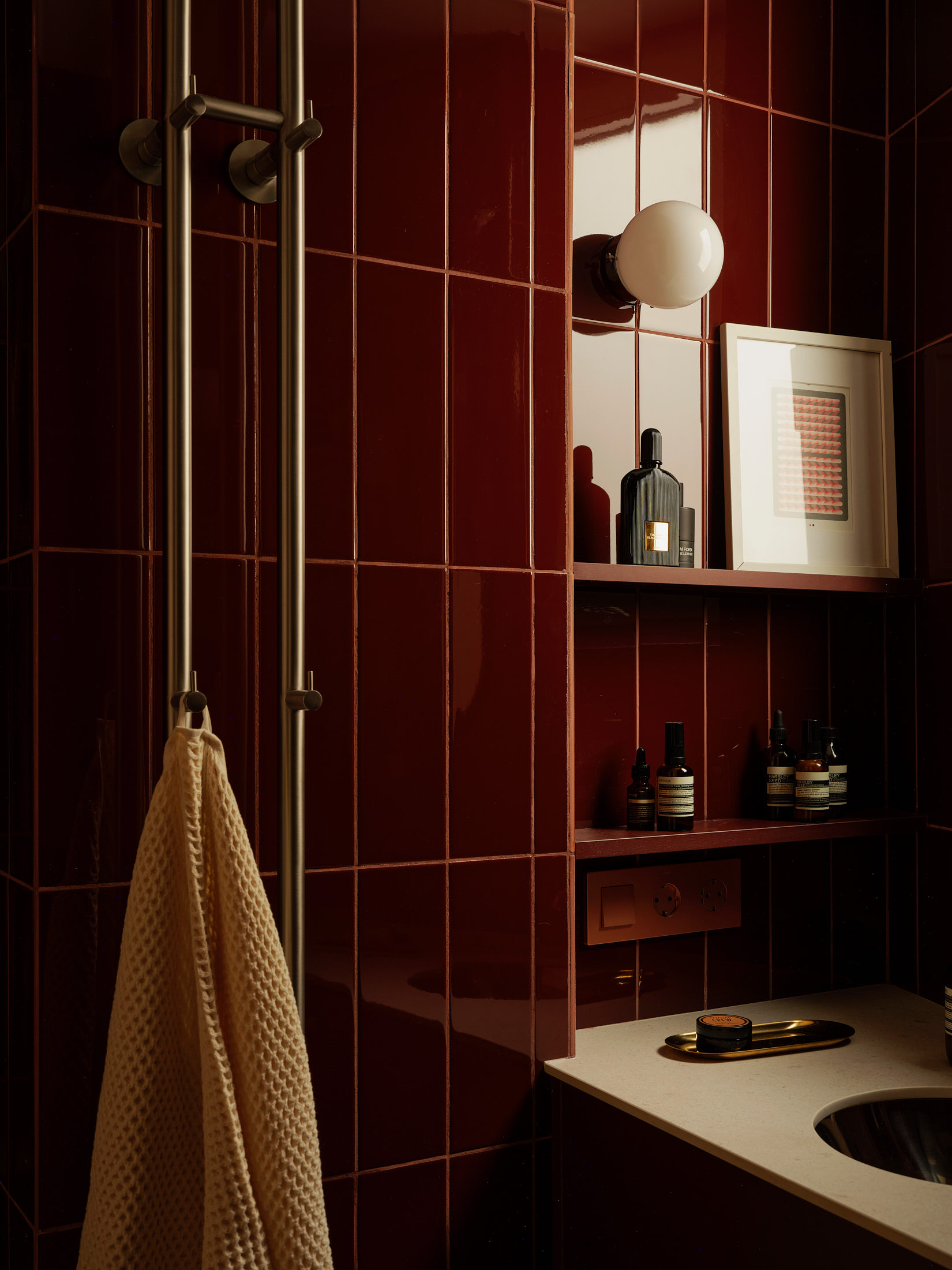 Viladomat Apartment in Barcelona by Colombo Architecture - detail of bathroom shelving in burgundy red