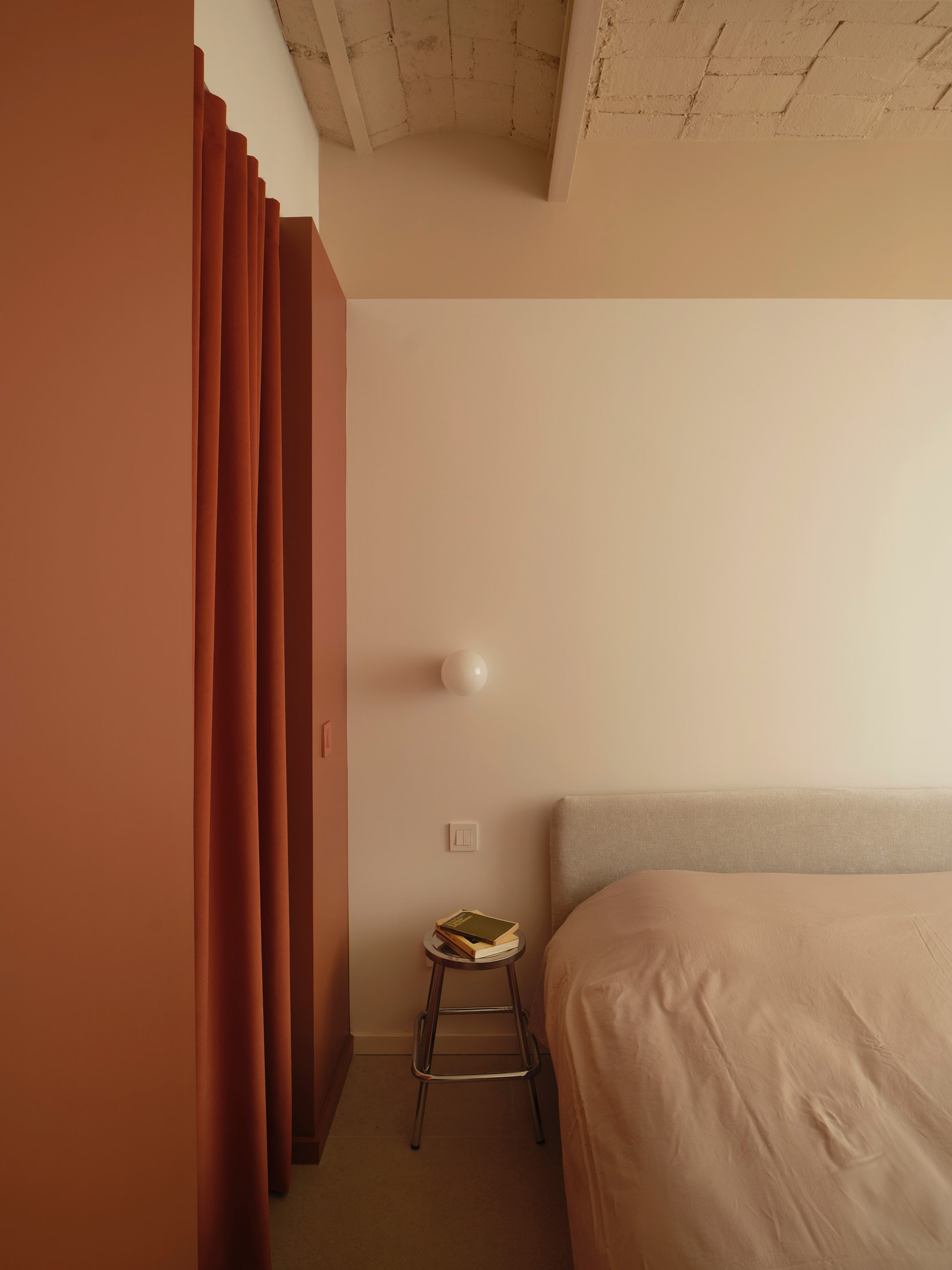 Viladomat Apartment in Barcelona by Colombo Architecture - bedroom with curtain separating the walk-in closet