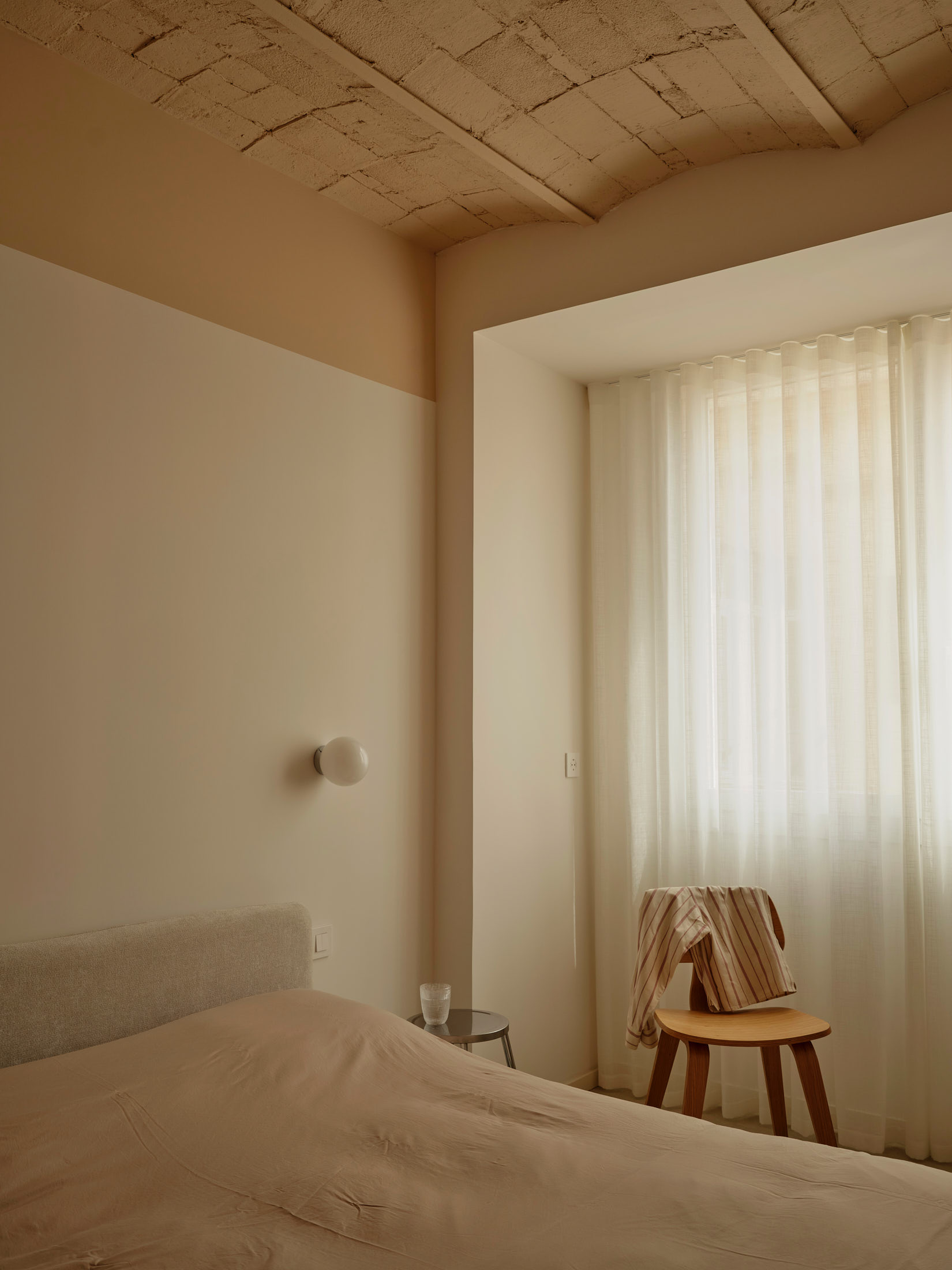 Viladomat Apartment in Barcelona by Colombo Architecture - bedroom with wall to wall white curtain