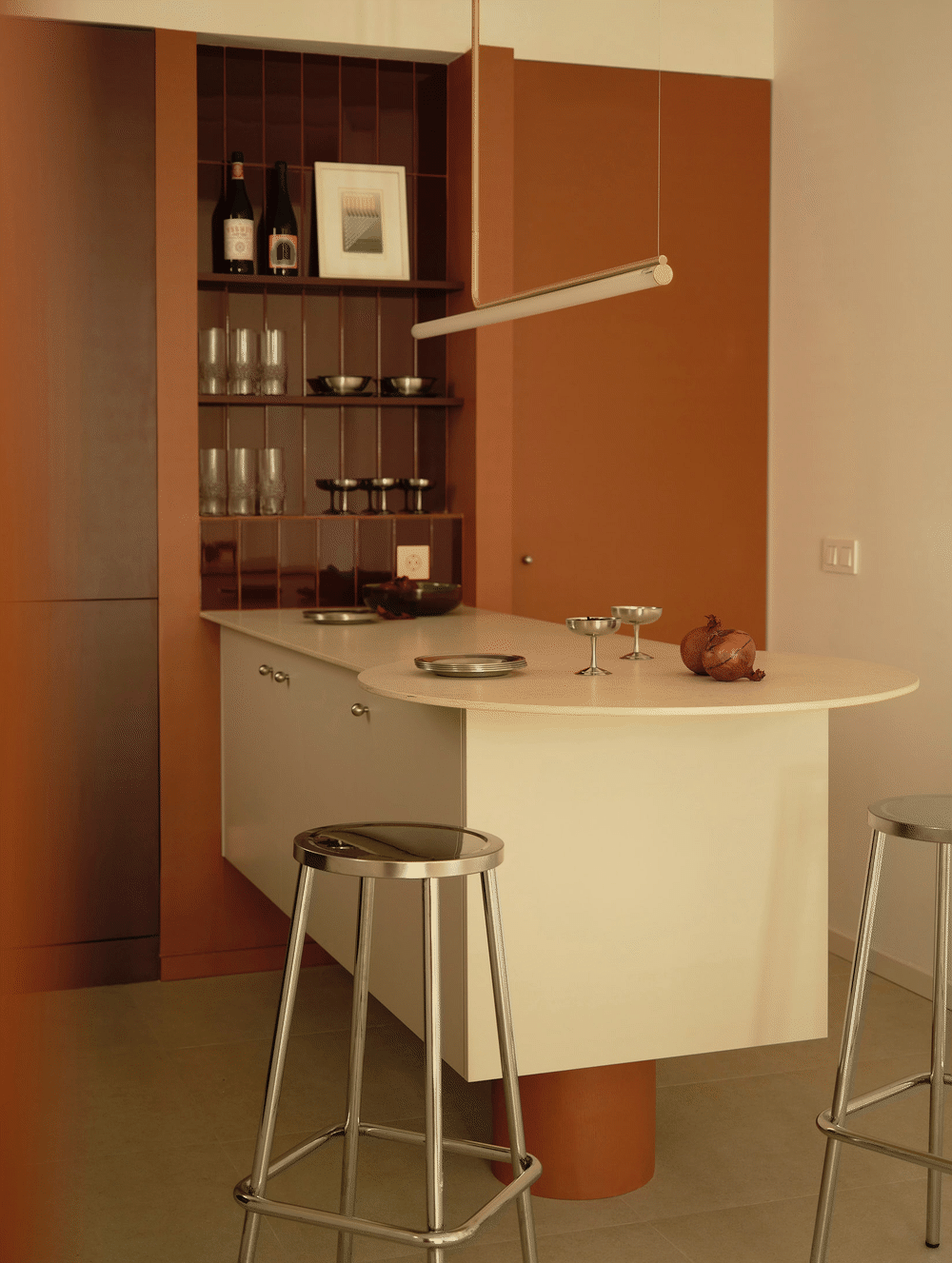 Viladomat Apartment in Barcelona by Colombo Architecture - the pivoting door in the clay red block opening from the kitchen to the private area